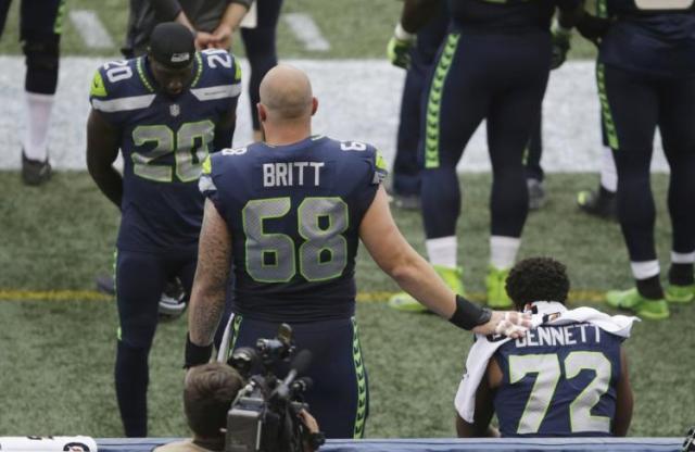 Center Justin Britt, who is white, stood next to Michael Bennett with his hand on the defensive end’s shoulder.